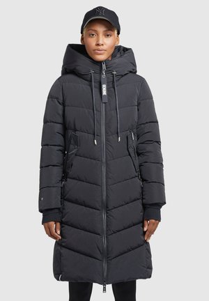 Black puffer coat with a hood, featuring a front zipper, two side pockets, and quilted pattern. Soft fabric with ribbed cuffs.