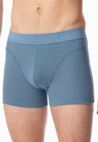 Blå kalsonger av stretchigt material med ett diamantmönster, med en solid midjeband för en säker passform.