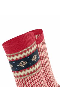 Knielange rote Socken mit einem geometrischen Muster in Creme und Dunkelblau, verziert mit Blumenmotiven und Zickzack-Designs.