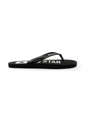 Musthave must jalats, millel on tekstuuriga rihmad ja tasane tall. Tootel on esile toodud silmapaistev valge logo ja staarimuster sääreluu osas. Minimalistlik disain.