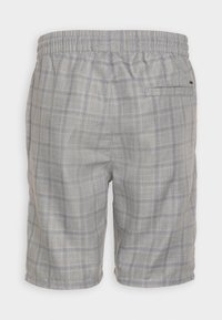 Pantaloni corti a quadri grigi con vita elastica, caratterizzati da linee blu e gialle, e una tasca sul retro per maggiore funzionalità.