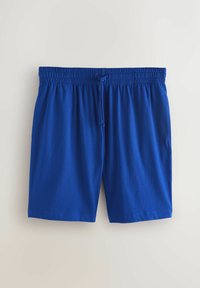 Blå elastiske shorts med taljebånd, snøre foran og sidelommer, lagt fladt på en lys baggrund.
