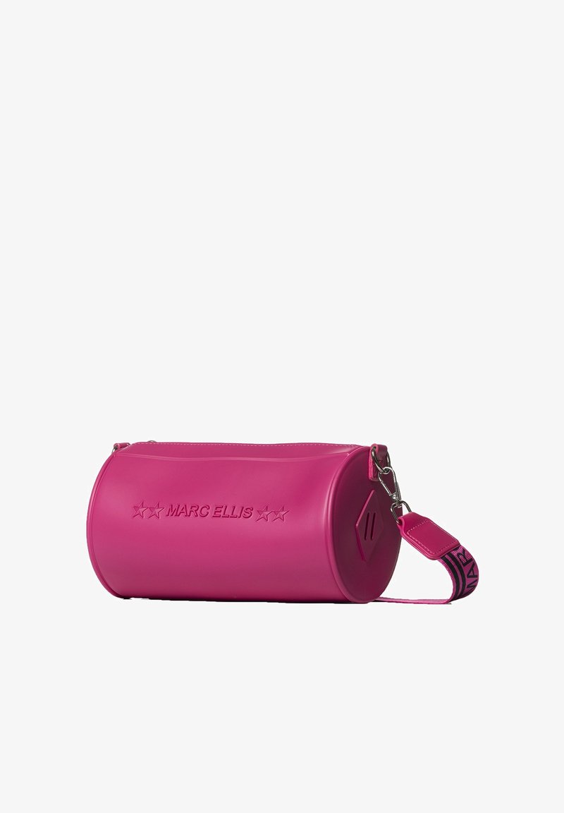 Pink cylindrical bag made of smooth material, featuring a zip closure, silver hardware, and a detachable strap with a patterned accent.