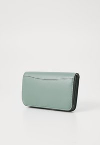 Mint green leather wallet with a smooth texture, rectangular shape, rounded edges, and contrasting stitching along the perimeter.