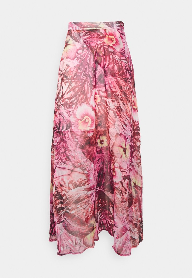 Longue jupe fleurie rose avec tissu transparent superposé et motifs de feuilles et de fleurs tropicales sur fond uni.