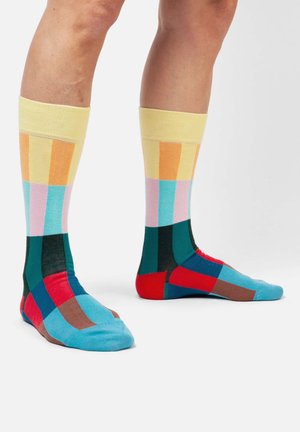 Bunte knielange Socken mit einem Gittermuster in den Farben Gelb, Pink, Blau, Grün und Rot; weiche Stofftextur; gerippte Bündchen.