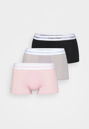 Three pairs of men’s boxer briefs in black, gray, and light pink. Made of smooth fabric with a white Calvin Klein logo waistband.