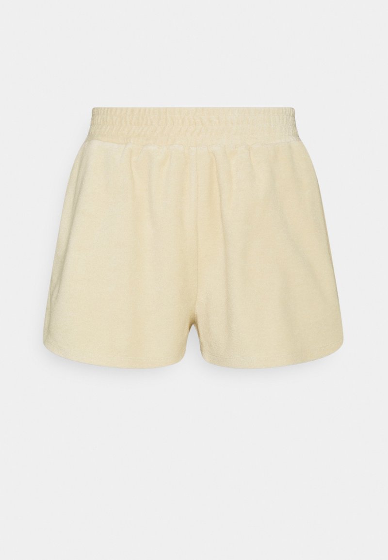 Shorts en éponge de coton de couleur beige clair. Présentent une taille élastique et une coupe décontractée, avec une texture douce et un minimum de détails.