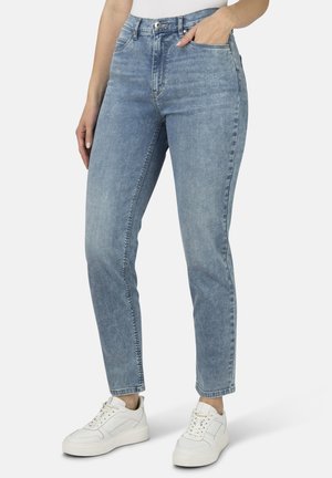 Light blue, high-waisted jeans with a straight-leg design, featuring front pockets and a subtle faded texture, paired with white sneakers.