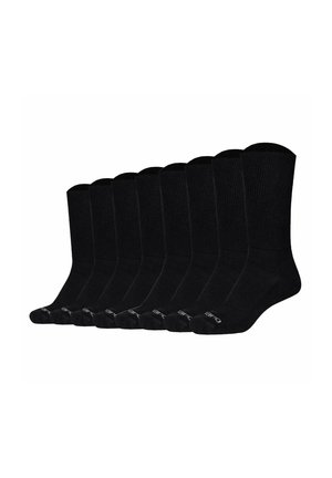 Neuf paires de chaussettes noires unies, disposées côte à côte, espacées uniformément, sur fond blanc.