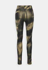 Leggings pretas com um padrão abstrato dourado, feitas de um material elástico, apresentando uma cintura alta e um design que se ajusta ao corpo.