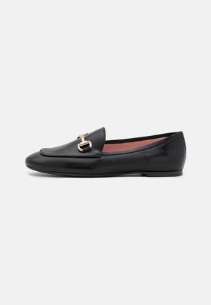 Black leather loafer with a sleek design, rounded toe, and gold hardware accent on the front. Smooth texture with a low flat sole.