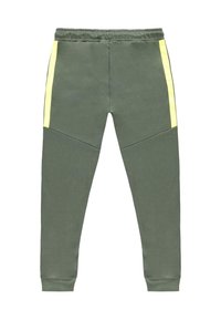 Groene joggingsbroek met neongele zijkanten, gemaakt van zacht materiaal. Heeft een elastische tailleband en taps toelopende enkelmanchetten.