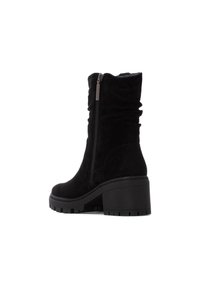 Botín de ante negro hasta el tobillo con tacón grueso, cremallera lateral, diseño fruncido y suela texturizada. Acabado liso y sin detalles de hardware visibles.