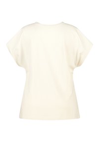 T-shirt crème à manches courtes avec une coupe ample et un col rond, fabriqué en tissu coton doux. Design minimaliste, sans motifs ni accents visibles.