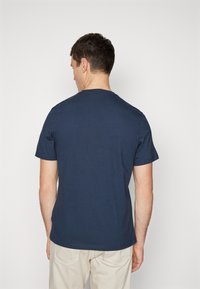 Navy blue short-sleeve t-shirt with a round neckline, made of soft cotton. Simple design, no visible logos or patterns. Back view.