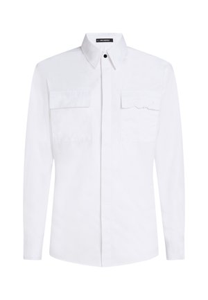 White cotton long-sleeve shirt with button-down collar, two chest pockets, and subtle embroidered logo detail on the left pocket.