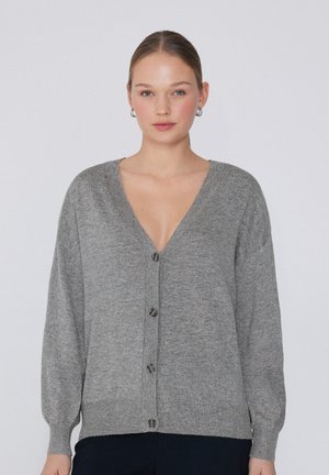 Cardigan gris en matériau tricoté doux, avec un col en V, des manches longues, une fermeture à boutons sur le devant et des détails côtelés à l'ourlet.
