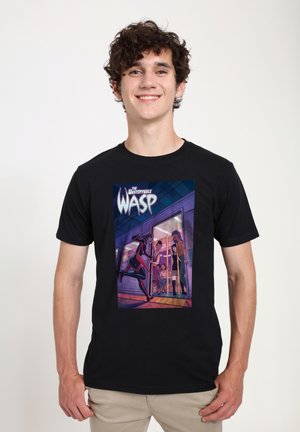 Black cotton t-shirt featuring a colorful graphic print of "The Unstoppable Wasp," depicting characters in a vibrant scene.