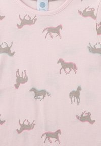 Light pink T-shirt featuring a repeated pattern of gray horses with pink and blue accents. Soft, cotton material, round neckline.