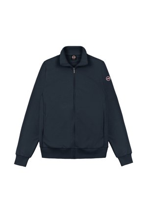 Mørkeblå lynlåsjakke med opretstående krave, lange ærmer, ribstrikkede ærmekanter og en rund logopatch på den øverste venstre ærme.