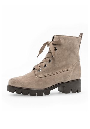 Beige suede ankle boot with a round toe, lace-up front, and a chunky, serrated black rubber sole. Features a pull tab at the back.