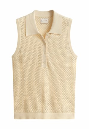 Haut en tricot sans manches de couleur crème avec un col et trois boutons, présentant un motif ajouré texturé et un ourlet côtelé.