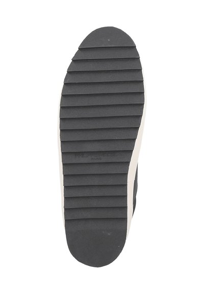 Black rubber shoe sole with horizontal ridges for traction, featuring a white accent along the edge and embossed brand name.