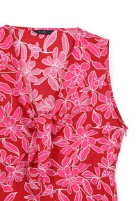 Red sleeveless blouse featuring a floral pattern in pink and white. The neckline is V-shaped with a knot detail at the waist.