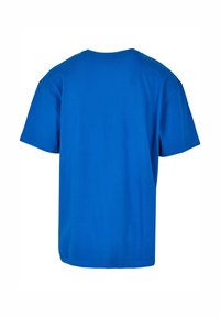 Camiseta de algodón azul con escote redondo y mangas cortas. La vista trasera muestra un color sólido y suave sin patrones ni acentos.