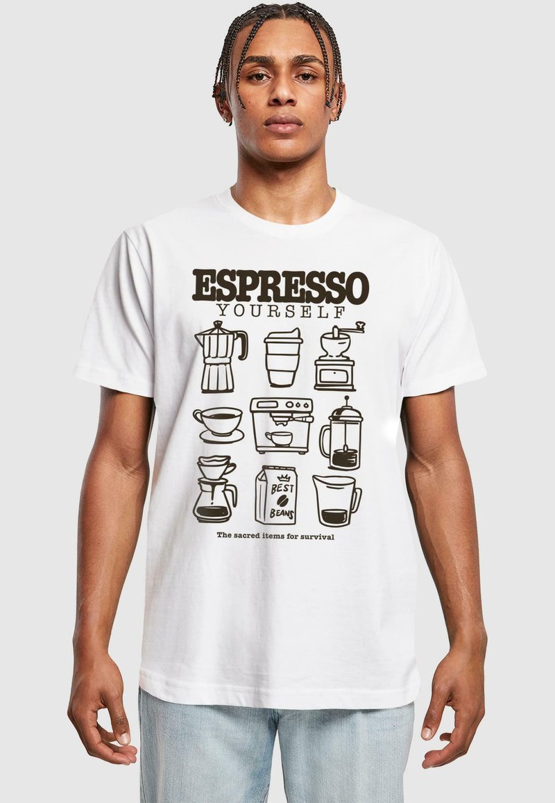 White t-shirt featuring black illustrations of coffee-related items. Text reads: "ESPRESSO YOURSELF." Below, it says, "The sacred items for survival."