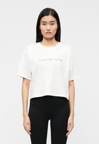 T-shirt branca cropped feita de algodão, com logótipo "MICHAEL KORS" em relevo na frente. Mangas curtas e corte descontraído.