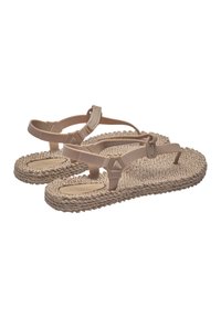Beige sandals with woven jute soles, featuring two adjustable straps and a flat design for comfort. Textured outsole for grip.