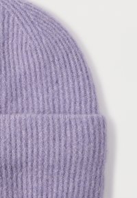 Lavender wool beanie with a ribbed texture, featuring a folded cuff. The fabric appears soft and slightly fluffy.