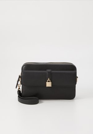 Musta nahkakotelo vetoketjulla, jossa on etuohjaus, kultasävyiset varusteet ja koristeellinen lukko. Sileä pinta.