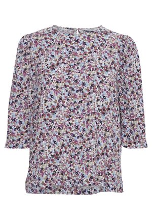 Blouse florale avec un fond bleu clair orné de fleurs violettes, roses et noires, col rond et manches trois-quarts.