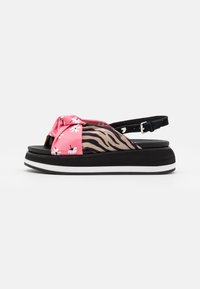 Adjustable slingback sandal with a black and white platform, featuring a pink floral and zebra-print fabric upper.