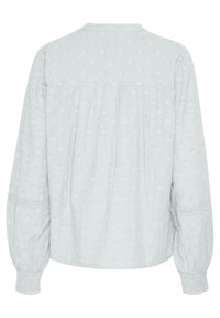 Hellgraue Bluse mit strukturiertem Blumenmuster, gerafftem Rücken und Ballonärmeln. Verfügt über Spitzenbesatz an den Bündchen und elastische Handgelenksöffnungen.