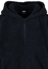 Black fleece hoodie with a zip closure and a textured, cozy surface. Features a large hood and no additional accents or patterns.