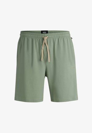 Shorts vert clair en tissu doux, avec une ceinture élastique munie d'un cordon beige, et un petit logo brodé sur la jambe.