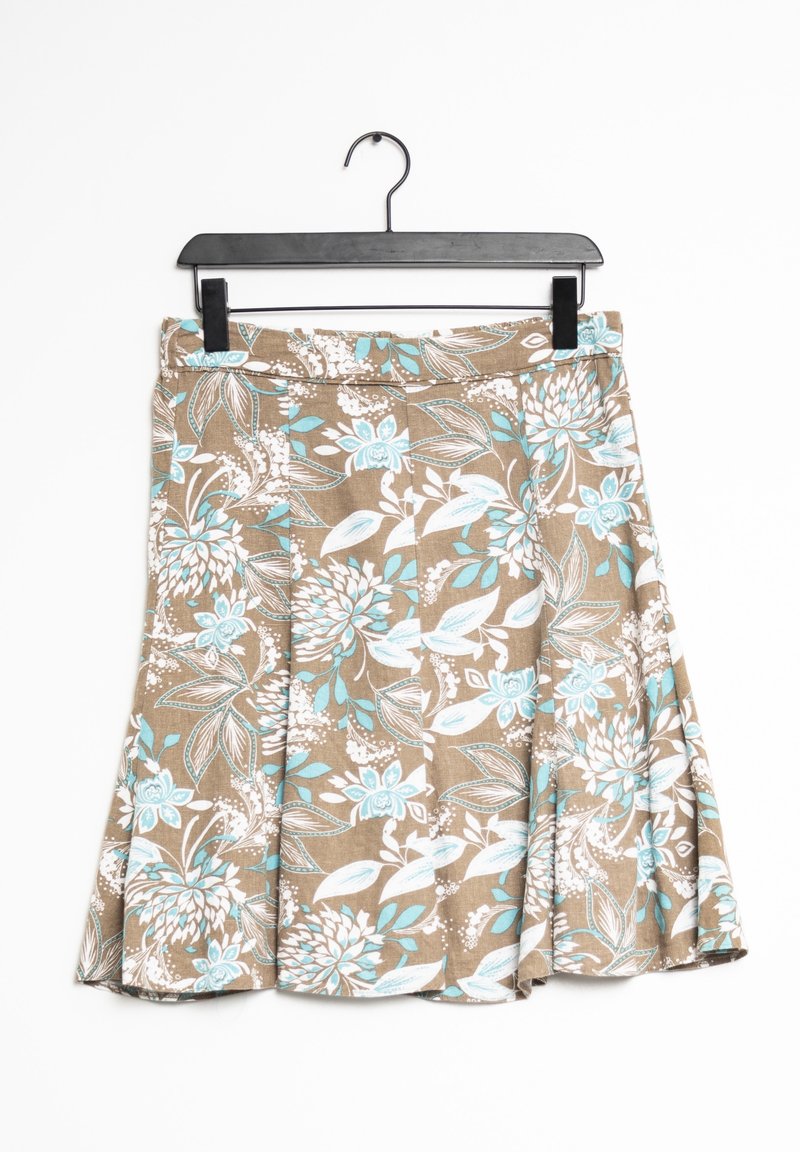 Brun nederdel med hvidt og turkis blomsterprint hængende på en sort bøjle mod en hvid baggrund.