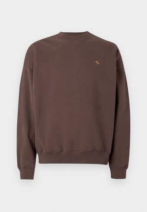 Brun crewneck sweatshirt i mjukt tyg, med ribbad mudd och nederkant, samt en liten broderad design på vänster bröst.