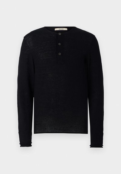 Must helelisest mustast henley-särgist, mis on valmistatud pehmest kangast, ümar krae ja kolm esist nuppu. Veidi lõdva istuvusega, ribakujulised mansetid.