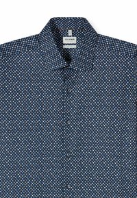 Navy blue button-up shirt featuring a small, repeated leaf pattern in light blue and brown. Fabric has a smooth texture. OLYMP label visible.