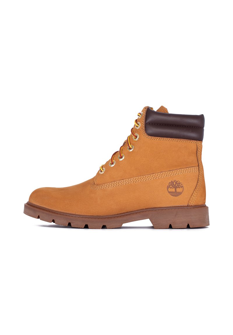 Tan leather lace-up work boot with padded dark brown collar, rugged sole, and embossed tree logo on the side, shown in profile view.