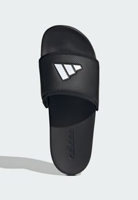Black slide sandal with a perforated strap, featuring a silver Adidas logo, textured footbed, and smooth sole.