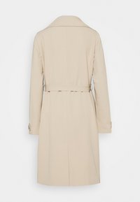 Beige trench coat with a long silhouette, single vent at the back, and belted waist. Features long sleeves and buttoned cuffs.