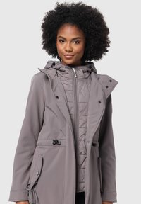 Gray softshell coat with a quilted inner layer, adjustable drawstring hood, zip closure, and side pockets with button accents.