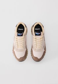 Pair of beige and brown Blauer USA sneakers with cream laces, black insoles, and brand logo on tongue and side, viewed from above.