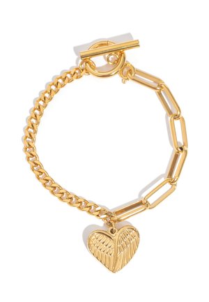 Gold bracelet with mixed chain links and a heart-shaped charm featuring a detailed wing design, secured by a toggle clasp.